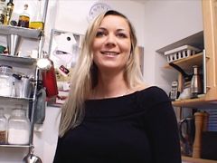 Outstanding German MILF with huge boobs dildoing her shaved muff in the kitchen